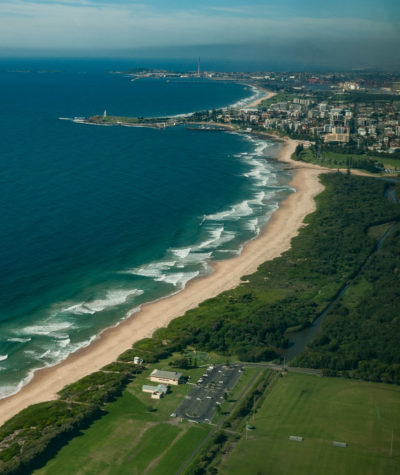 This is an aerial shot of Fairy Meadow beach with Puckey's Estate partially shown.